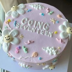 a pink cake with white frosting that says going seventien