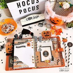 a table topped with lots of halloween decorations and paper work on top of each other