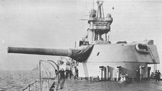 an old photo of a large battleship in the middle of the ocean with people standing on it