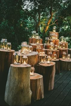 many candles are lit on wooden logs