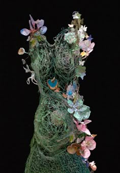 there is a sculpture made out of wire and flowers