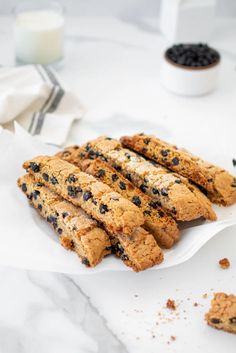 some cookies are on a white plate with blueberries