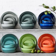 colorful plates are lined up on a shelf