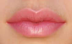 close up view of the lips of a woman with pink lipstick on her face royalty images