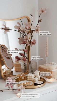 a white dresser topped with lots of different types of flowers and jewelry on top of it