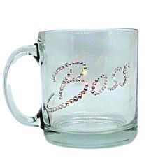 a glass mug with the word god on it and beaded hearts in the middle