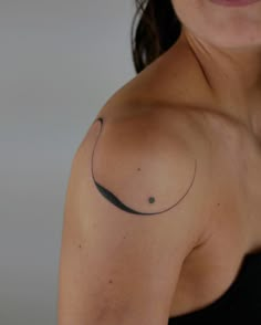 a woman's arm with a tattoo on it that has a crescent moon in the middle