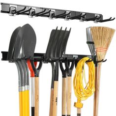 a rack with various tools hanging from it's sides, including brooms and rakes