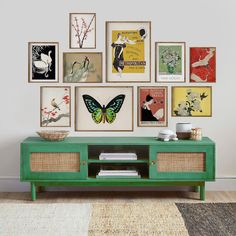 a living room with many framed pictures on the wall and a green entertainment center in front of it