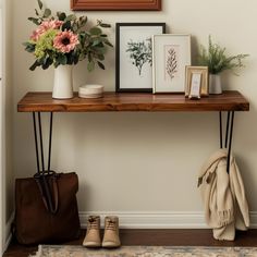 a wooden shelf with flowers and pictures on it next to a handbag, purse and shoes