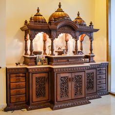 an elaborately carved wooden cabinet in a room