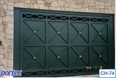 a green garage door with gold studs on it