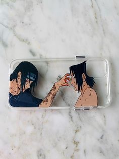 two cell phones with anime characters on them sitting next to each other in front of a marble surface