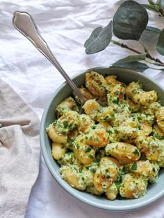 a bowl filled with potatoes and garnished with herbs