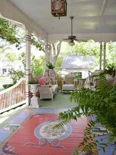 the porch is decorated with colorful rugs and wicker furniture