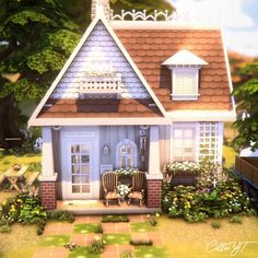 a small house with flowers and plants around it