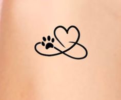 a dog paw and heart tattoo on the back of a woman's stomach