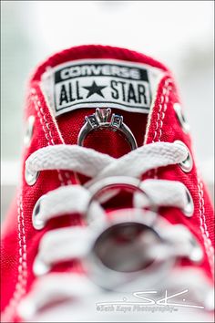 a red sneaker with the converse all star logo on it