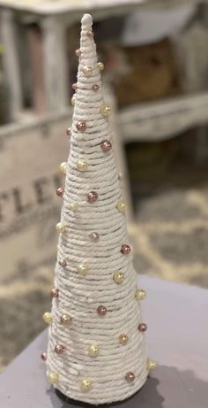 a small white christmas tree sitting on top of a table