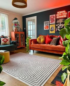 a living room with two couches and a rug on the floor in front of a window