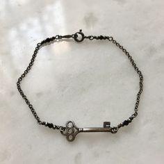 This unique Dainty Key Bracelet from our Hekate Talisman Collection is a perfect accessory for spiritual seekers, witches, and those drawn to the energy of the Goddess Hekate. Designed with symbolic elements, the bracelet is paired with Black Spinel, known for enhancing intuition and warding off negative energies. It's not just a piece of jewelry, it's a source of empowerment and a constant reminder of Hekate's wisdom and guidance. Perfect for everyday wear or special occasions, this piece makes Witchy Accessories, Goddess Hekate, Witch Bracelet, Key Bracelet, Talisman Jewelry, Witchy Jewelry, Message Jewelry, Black Spinel, Spiritual Jewelry