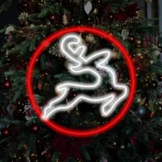 a christmas tree with a lit up reindeer ornament in the shape of a circle