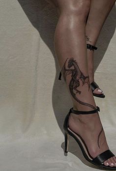 a woman's legs with tattoos on them