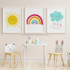 three children's art prints hang on the wall above a small table and chairs