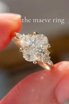 a close up of a person holding a diamond ring