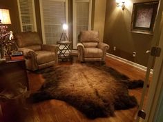 a living room with two recliners and a rug on the floor