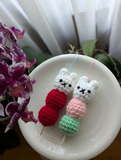 two crocheted carrots are sitting on a plate