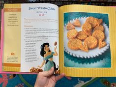 the inside pages of a book with an image of a princess holding a plate of cookies