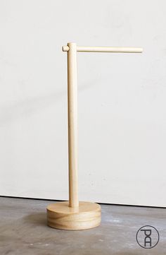 a wooden stand with a white wall in the background