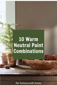 a table topped with pots and plants next to a green sign that says 10 warm neutral paint combinations