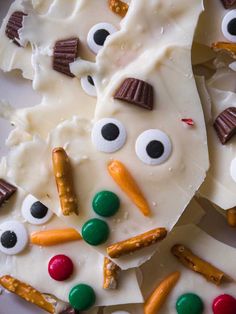 white chocolate with candy eyes, carrots and pretzels on it's side