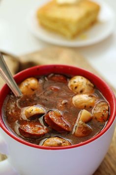 a red bowl filled with stew and some bread