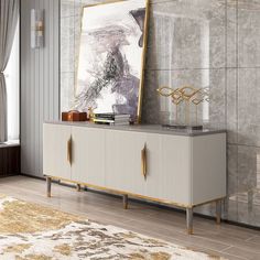 a white and gold sideboard in a living room with a painting on the wall