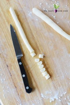 a knife and some cheese on a cutting board