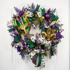 a wreath with mardi gras decorations on it