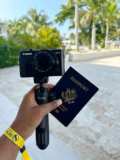 a person holding up a passport and a camera