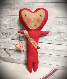 a red stuffed doll hanging on the wall