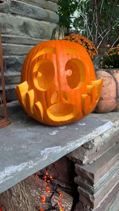 a carved pumpkin sitting on top of a fireplace