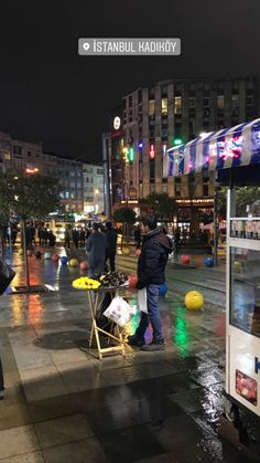 people are standing on the street in the rain