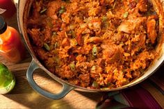 a large pot filled with food on top of a wooden table