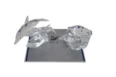 two crystal birds sitting on top of a metal stand with the number 2 in front of them