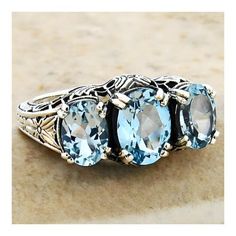 Vintage Estate Three Stone Natural 3.30 Carat Sky Blue Topaz Filigree Ring. 925 Solid Sterling Silver. The Top Of The Ring Measures 10mm Wide, 3/8 Inches At The Widest Point. Set With 3 Faceted Oval Cut Natural Sky Blue Topaz Stones. Stamped 925.  Excellent Condition/Like New. Elegant Filigree Ring With Blue Topaz Gemstone, Three Stone Topaz Ring In Sterling Silver, Elegant Aquamarine Three-stone Jewelry, Exquisite Topaz Ring For Anniversary, Elegant Blue Topaz Ring With Intricate Design, Elegant Filigree Ring With Blue Topaz Accent Stones, Elegant Three Stone Topaz Ring In Sterling Silver, Fine Jewelry Blue Topaz Filigree Ring With Intricate Design, Blue Topaz Filigree Ring With Intricate Design