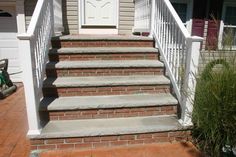 a white door and some steps in front of a house