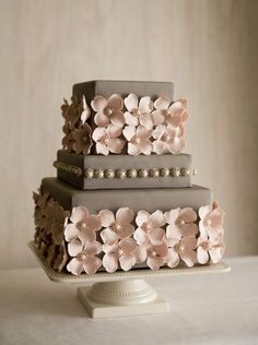 a three tiered cake with flowers on it