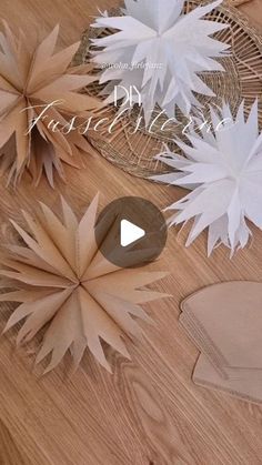 some paper flowers sitting on top of a wooden table