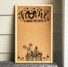 a wooden sign that says home is where the castle is